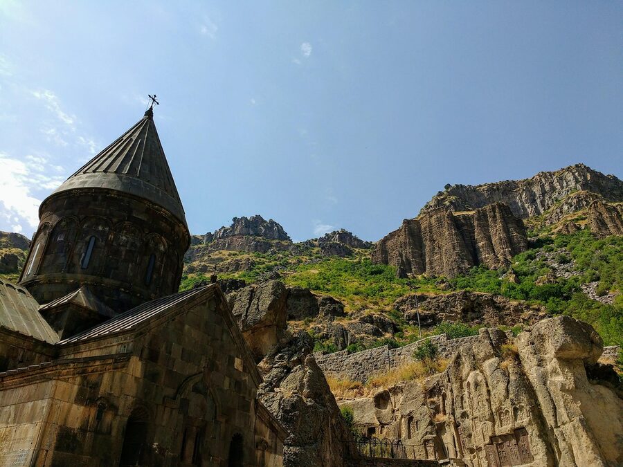 Cross atop Geghard Monastery against the sky