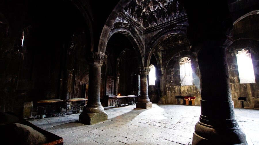 Vestry columns inside the gavit at Geghard, lit by a shaft of light