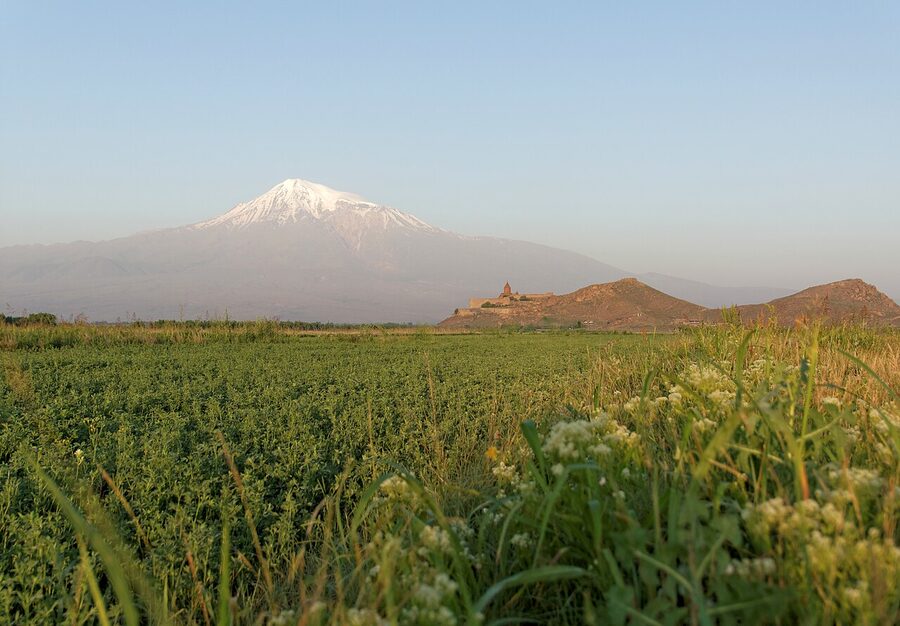 Sunrise light on Mount Ararat with Khor Virap on its hill in the foreground
