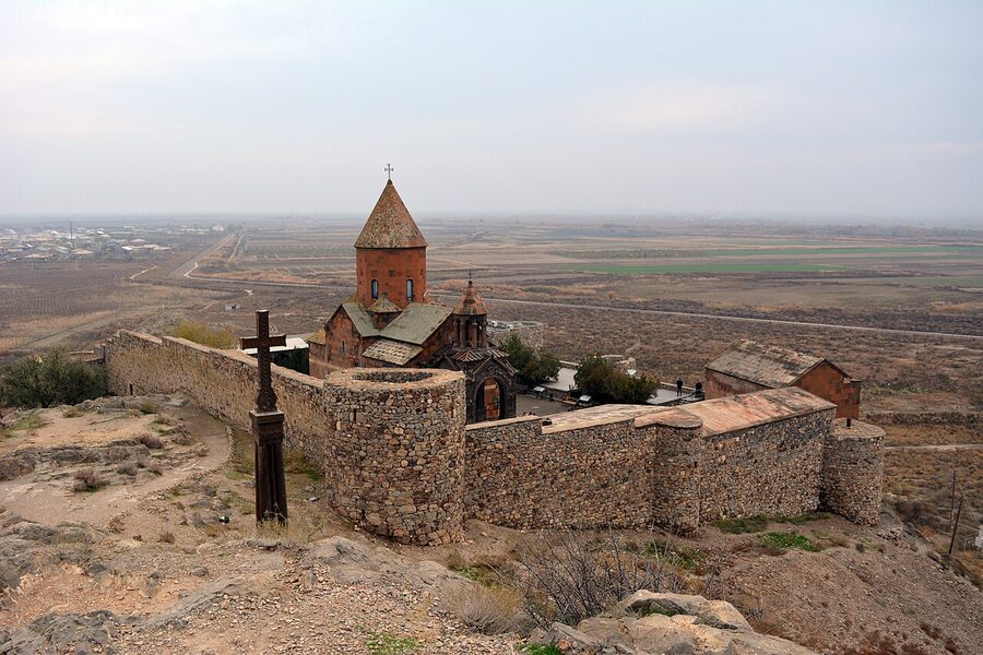 Khor Virap monastery on its hill with vineyards below
