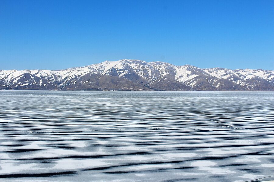 Lake Sevan frozen in winter with ice covering parts of the surface