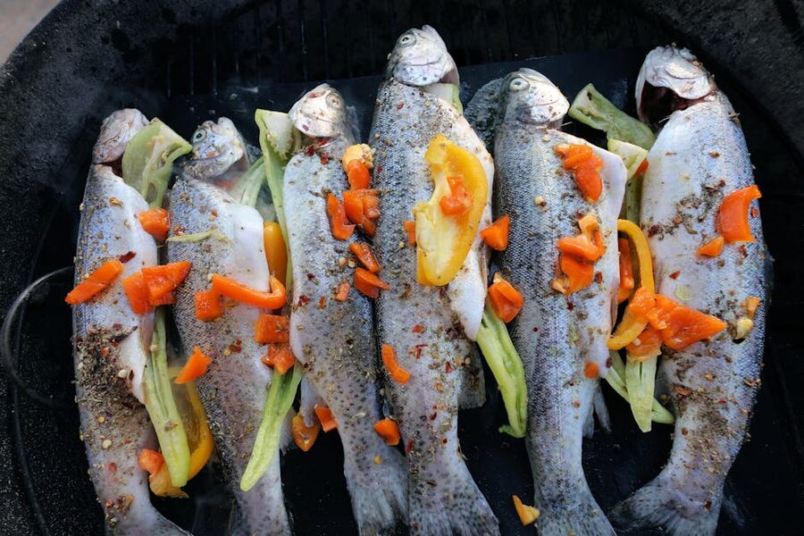 Freshly grilled trout with peppers and spices on a serving plate