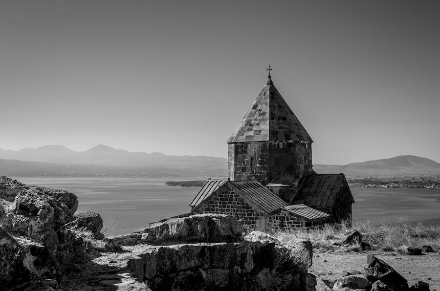 A historic chapel by Lake Sevan, Armenia, in monochrome