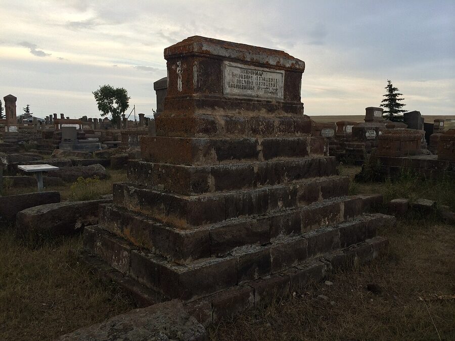 Detail of a carved khachkar at Noratus Cemetery showing the cross design and surrounding vegetal carving