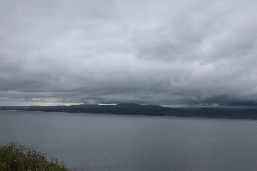 Lake Sevan water meeting mountainous shore in summer light