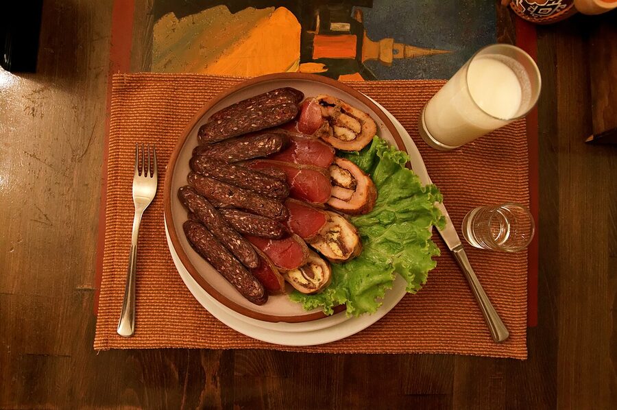 Sujukh and basturma cured meats sliced on a board