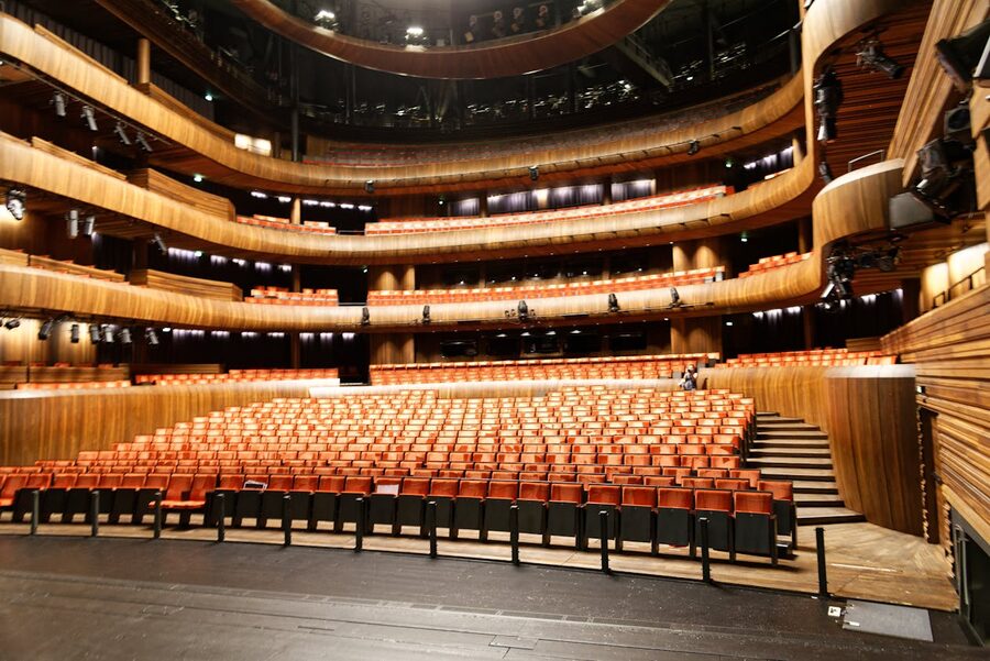 Empty modern theatre auditorium with wooden seats